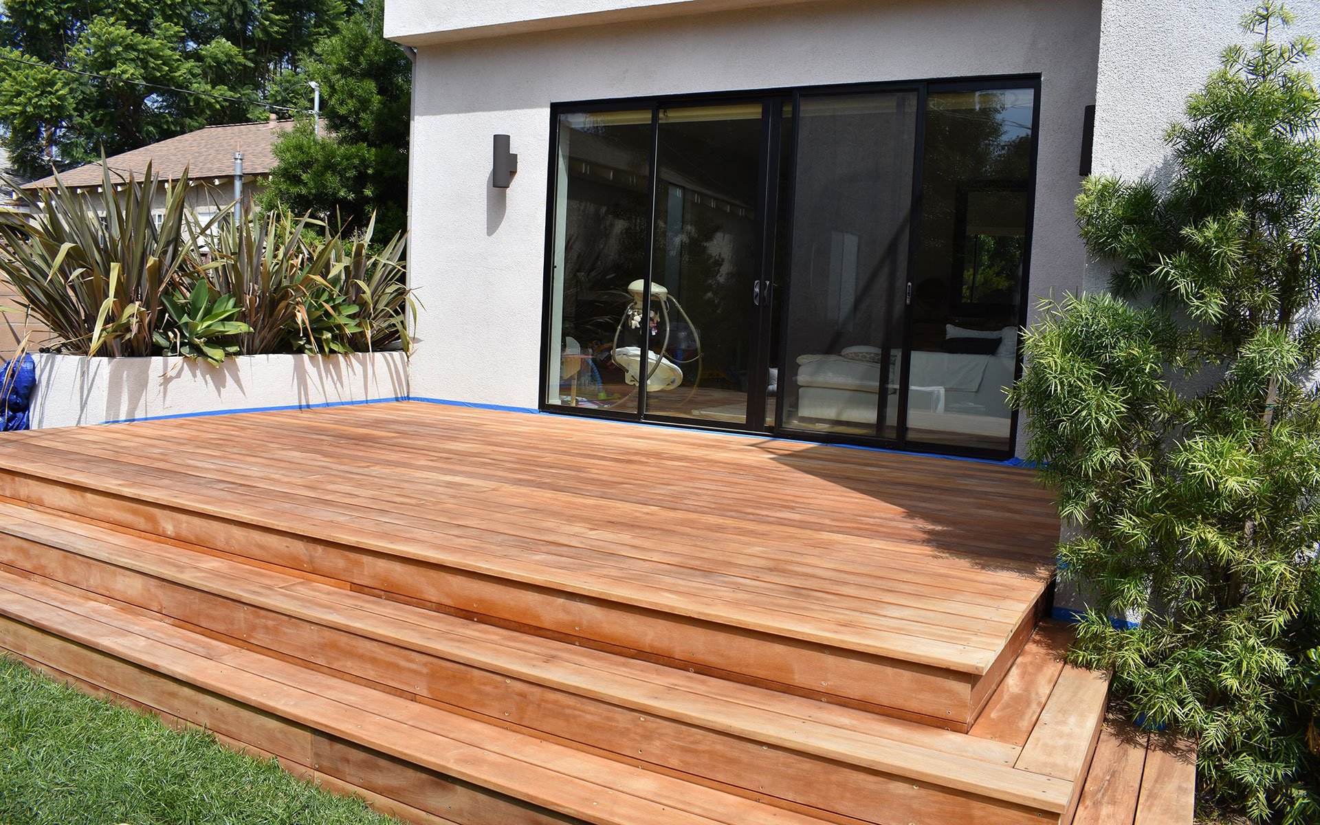 deck steps extending from broad sliding glass doors