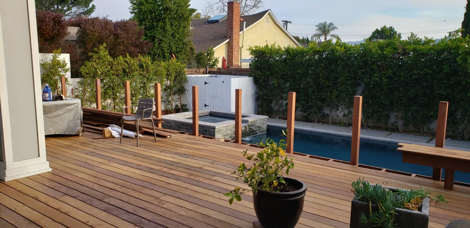 backyard deck being constructed with pool