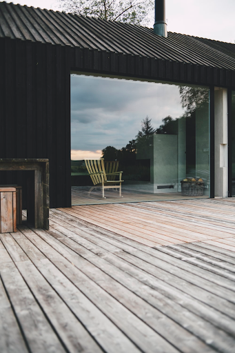 large glass wall behind an wooden deck