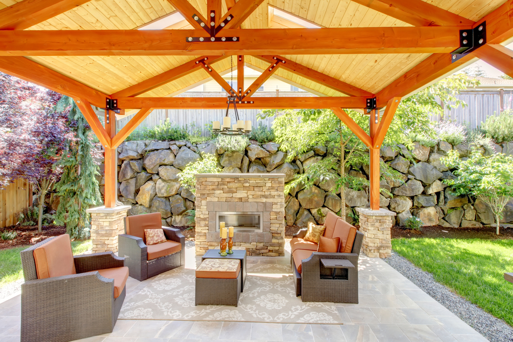 outdoor fireplace beneath wooden patio cover