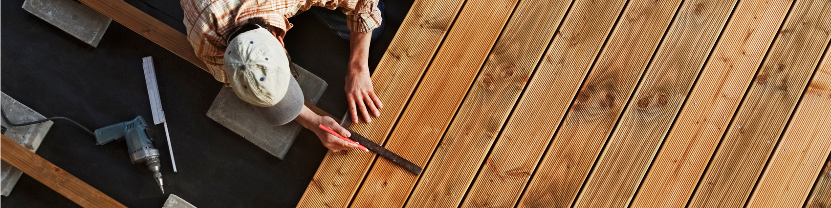 Man working on deck, laying boards.