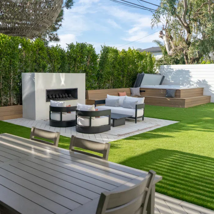 A renovated backyard that combines wood with stone and concrete. An example of mixing outdoor materials.